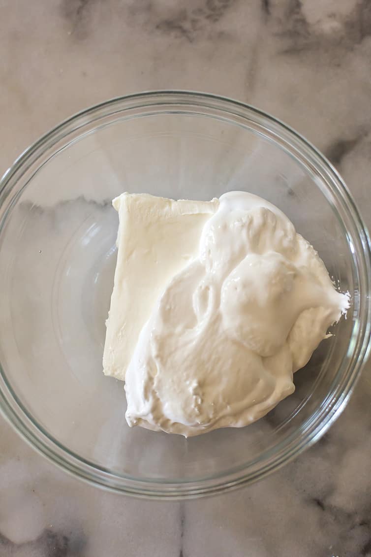 Cream cheese and marshmallow creme in a mixing bowl.
