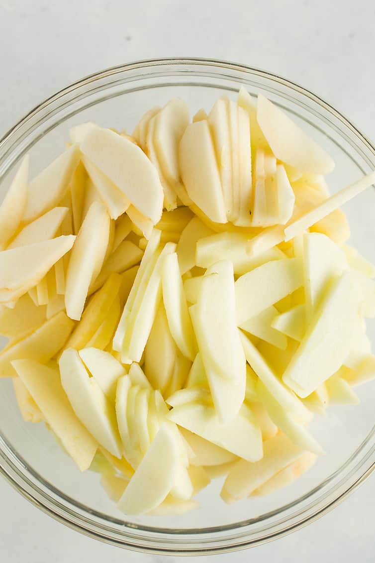 Sliced apples in a glass bowl.
