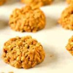 No bake peanut butter butterscotch cookies on a parchment paper lined baking sheet.