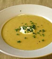 Creamy potato and leek soup in a white bowl.