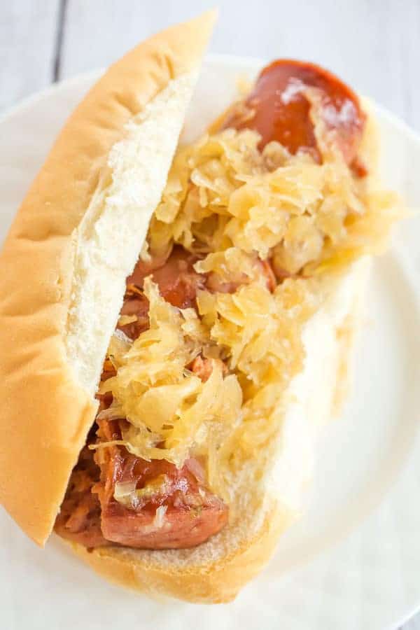 This slow cooker kielbasa and sauerkraut is flavorful and made with just the addition of beer and brown sugar - easy, delicious and perfect for parties!
