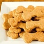Beef and cheddar dog biscuits on a white serving plate.