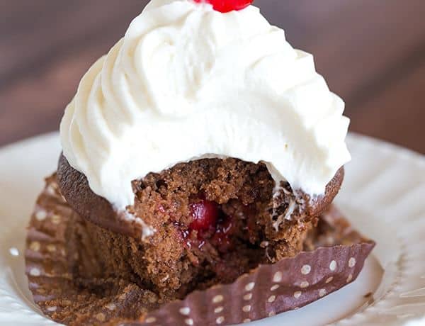 Cherry Coke Float Cupcakes - Chocolate cupcakes made with Coca-Cola, filled with cherries, topped with a Coca-Cola glaze, a whipped cream frosting and cherry on top!