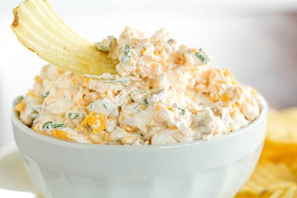 This loaded baked potato dip combines all of the fantastic flavors of a classic loaded baked potato - sour cream, bacon, cheese and scallions. Scoop away with potato chips!