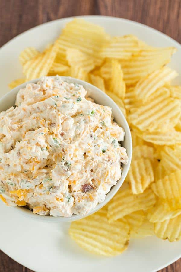 This loaded baked potato dip combines all of the fantastic flavors of a classic loaded baked potato - sour cream, bacon, cheese and scallions. Scoop away with potato chips!