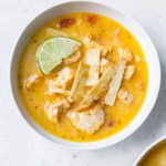 An overhead shot of a bowl of chicken tortilla soup.