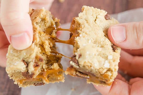 Salted Caramel Chocolate Chip Cookie Bars - A layer of salted caramel sauce is sandwiched between layers of a favorite chocolate chip cookie dough recipe, then topped with a sprinkle of fleur de sel.