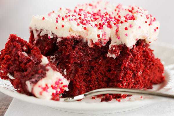 Red velvet cake is infused with sweetened condensed milk and topped with the best cream cheese frosting. A must for Valentine's Day!