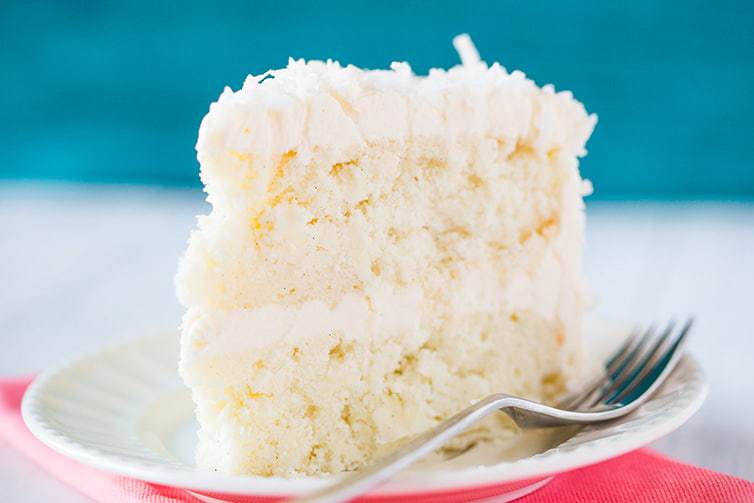 Coconut-Vanilla Bean Cake with Coconut Meringue Buttercream Frosting - A super moist coconut-packed layer cake and that frosting is a DREAM!