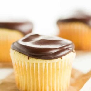 Boston Cream Cupcakes - Vanilla cupcakes filled with pastry cream and topped with chocolate ganache.