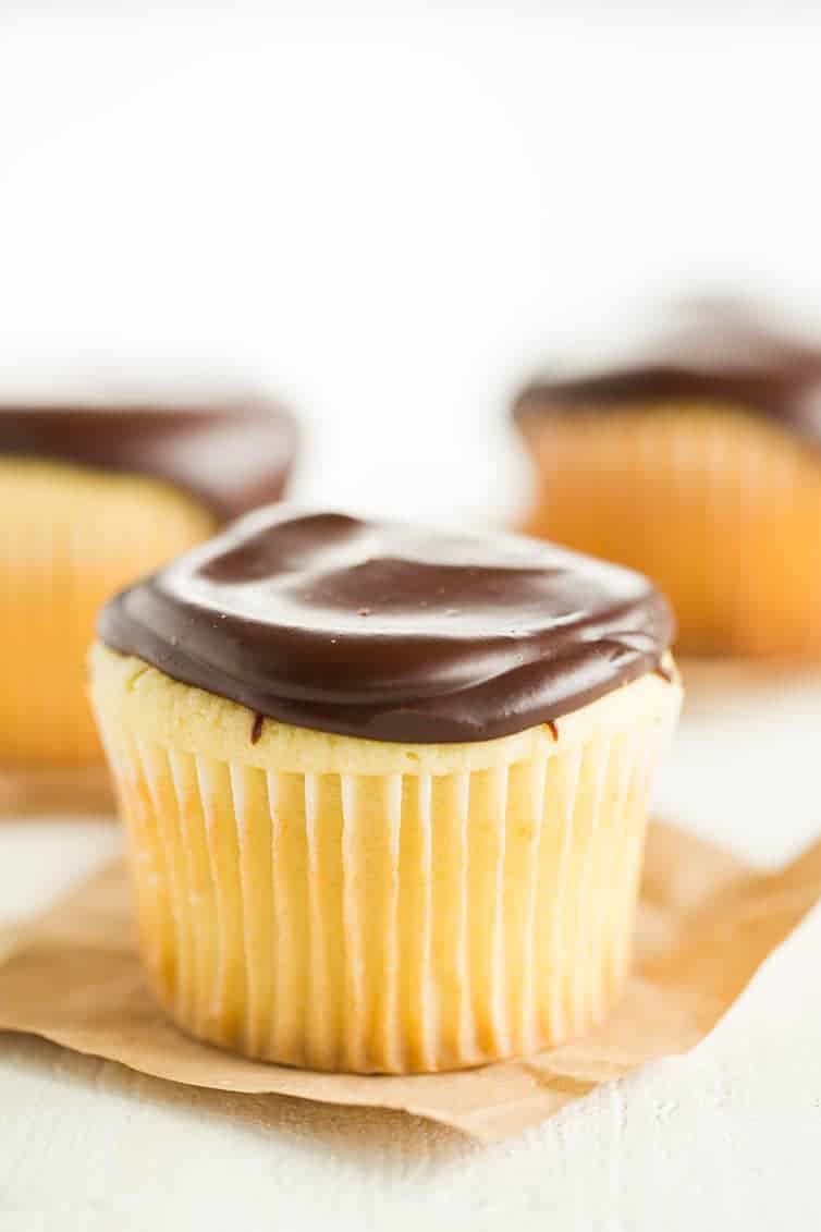 Boston Cream Cupcakes - Vanilla cupcakes filled with pastry cream and topped with chocolate ganache.