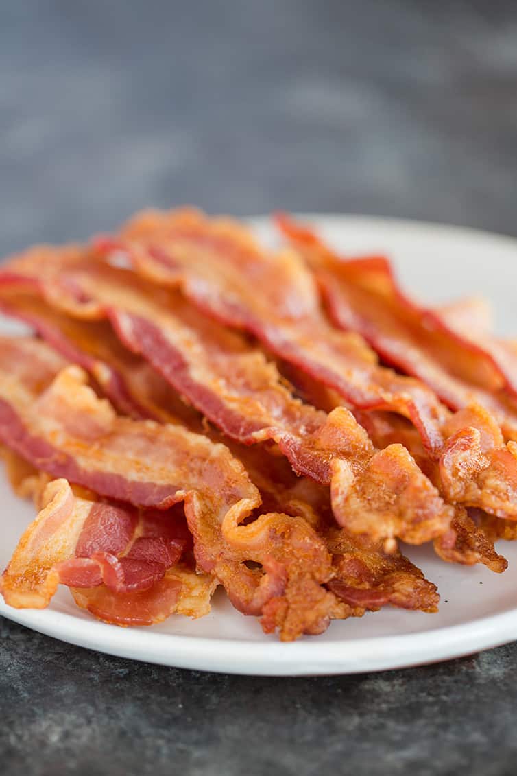 A plate piled high with oven baked bacon.