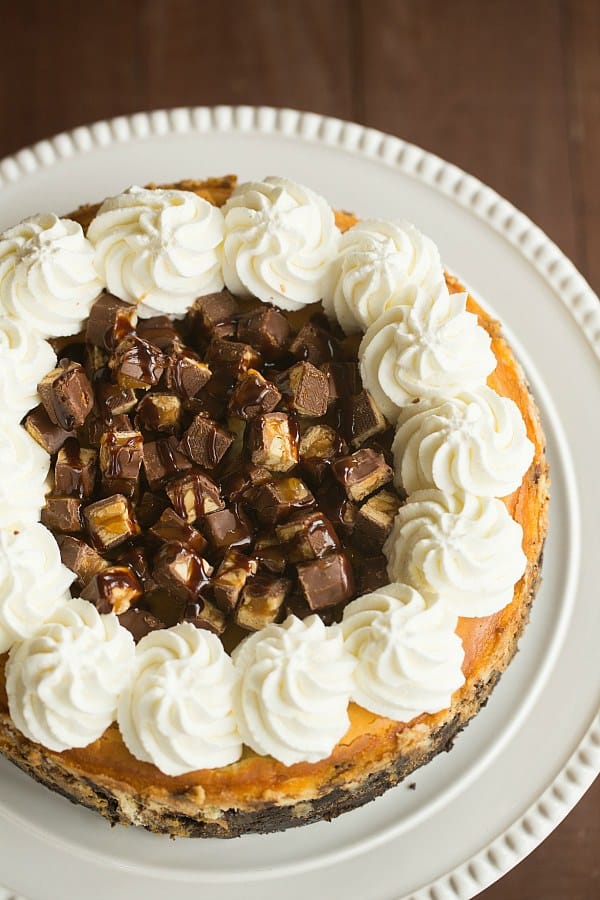 Snickers Cheesecake | browneyedbaker.com #recipe