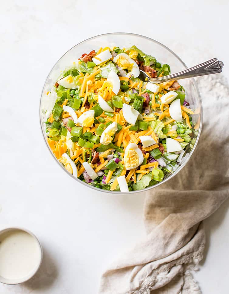 An overhead shot of a trifle bowl full of seven layer salad.