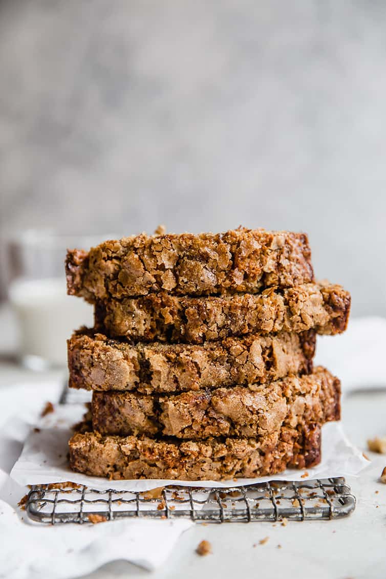 A stack of banana bread slices on a wire rack.