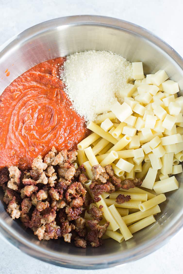 A big bowl with all of the ingredients for baked ziti.