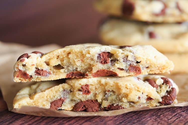 A chocolate chip cookie broken in half.
