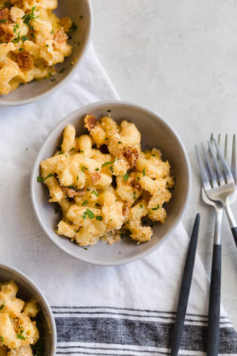An overhead shot of a bowl of mac and cheese with forks next to it.