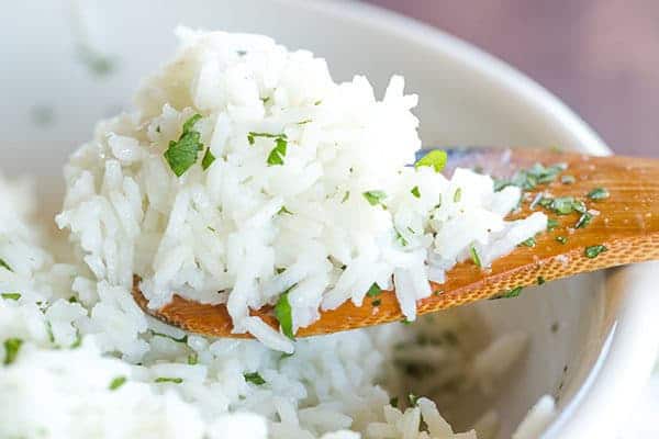 A copycat recipe for Chipotle's popular cilantro-lime rice, with a simple method to ensure light, fluffy rice with no clumps!