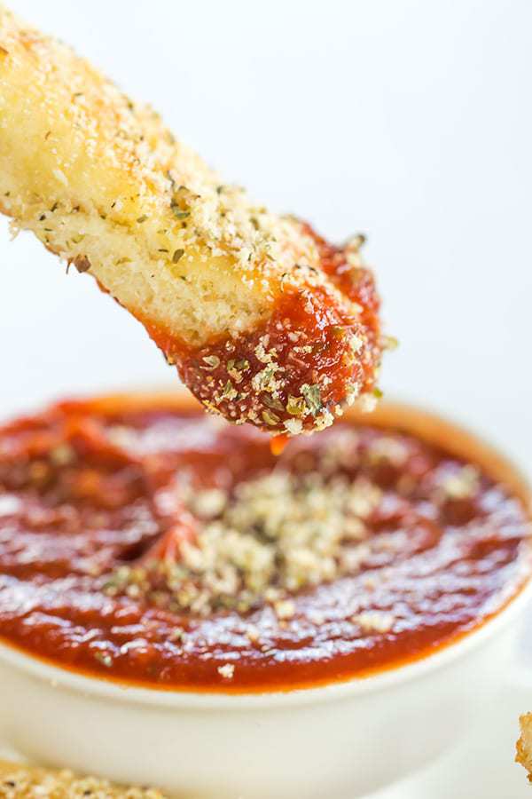 A copycat recipe for Pizza Hut breadsticks, made from scratch. Chewy, buttery, loaded with seasonings and an easy dipping sauce!