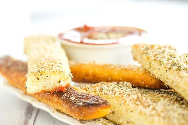 A copycat recipe for Pizza Hut breadsticks, made from scratch. Chewy, buttery, loaded with seasonings and an easy dipping sauce!