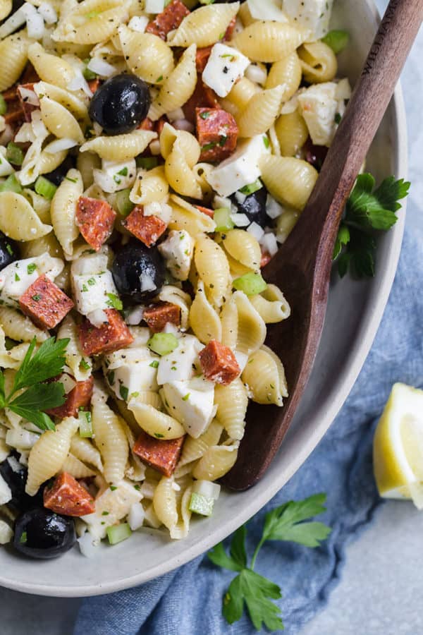 A close up overhead shot of pasta salad in a serving bowl.