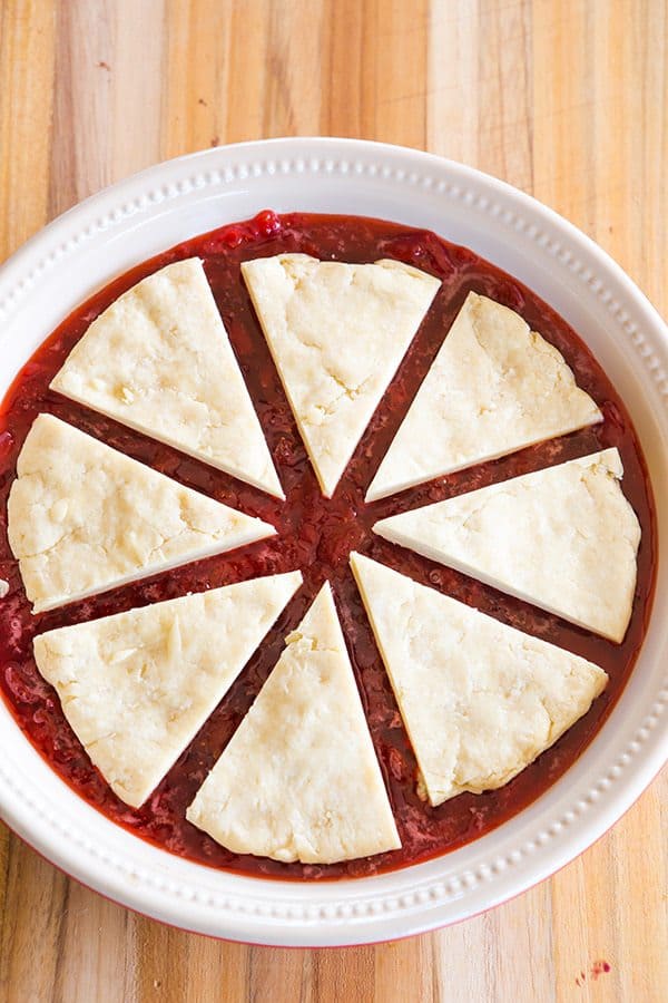 Cobbler-style biscuits are nestled on top of fresh strawberry jam and baked until bubbling and golden. A wonderful summer dessert!