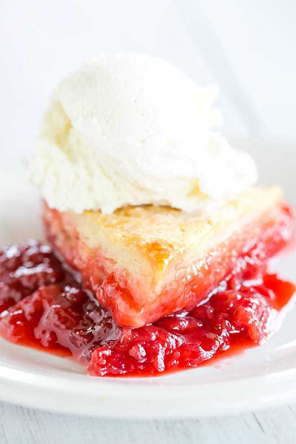 Cobbler-style biscuits are nestled on top of fresh strawberry jam and baked until bubbling and golden. A wonderful summer dessert!