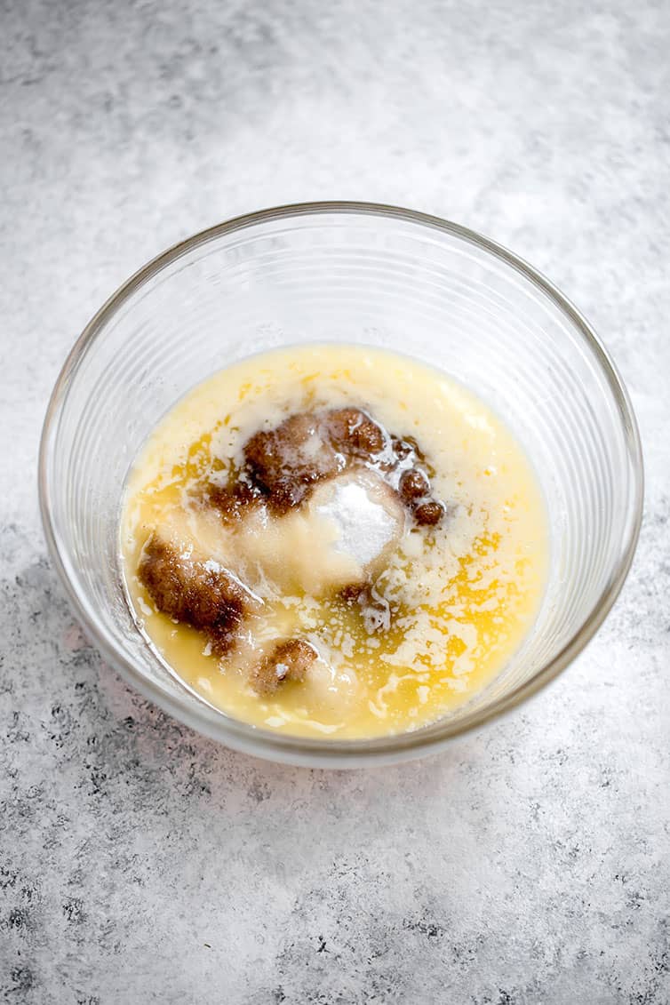 A mixing bowl with melted butter and brown sugar.