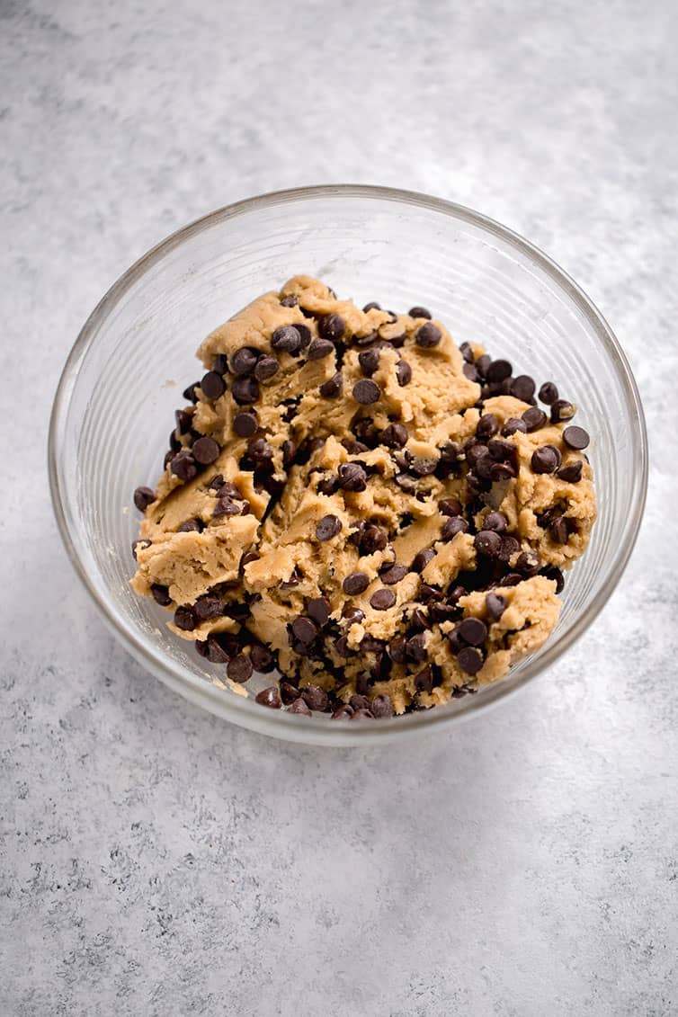 Chocolate chip cookie dough in a mixing bowl.