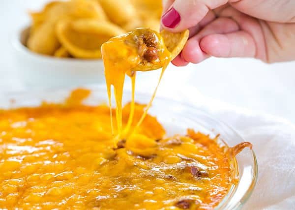This Cheesy Chili Dip is incredibly easy and perfect for parties, cookouts or watching the game. Only THREE ingredients!! 