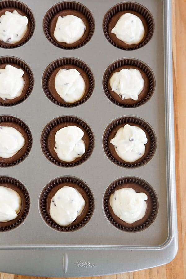 Classic black-bottom cupcakes - super moist chocolate cupcakes topped with a cheesecake filling and mini chocolate chips. The best of both worlds!