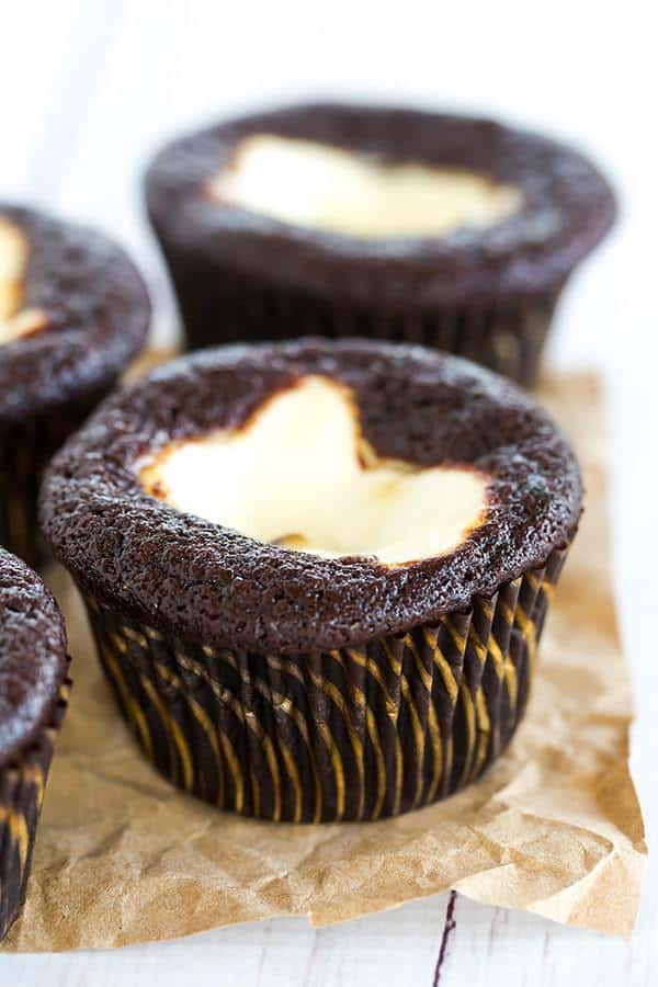 Classic black-bottom cupcakes - super moist chocolate cupcakes topped with a cheesecake filling and mini chocolate chips. The best of both worlds!