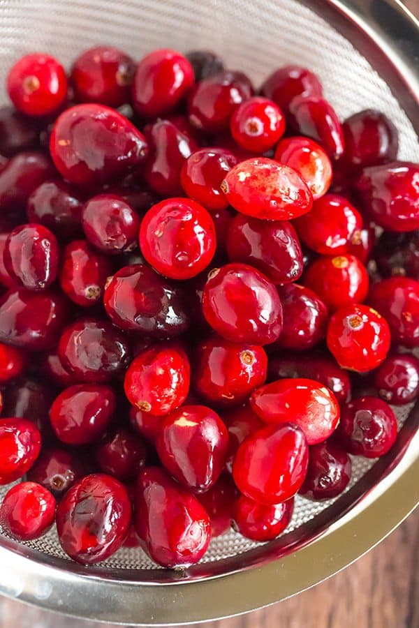 This Cranberry Pound Cake is wonderfully dense, moist and loaded with fresh cranberries. Topped with a simple orange glaze, it's perfect for the holidays.
