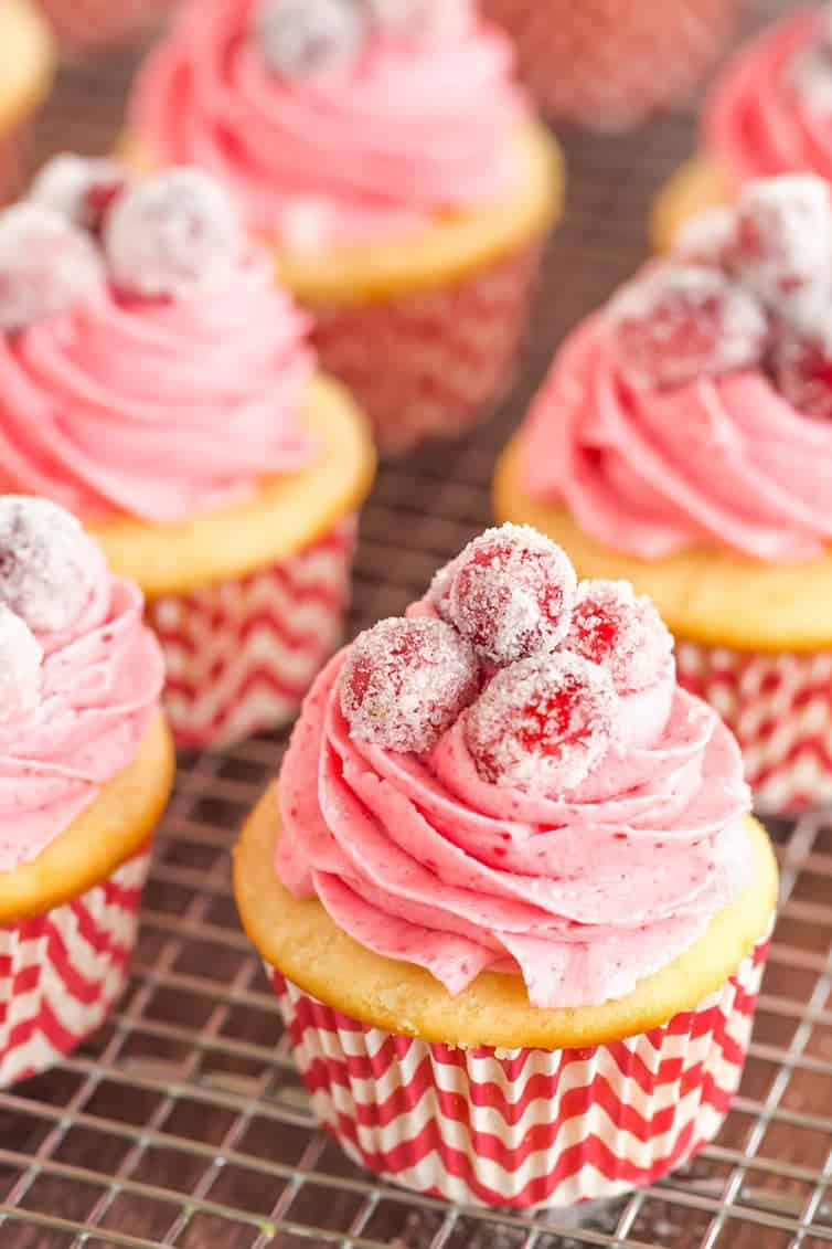 Sparkling Cranberry White Chocolate Cupcakes - Vanilla cupcakes with white chocolate ganache filling and cranberry buttercream frosting. | browneyedbaker.com
