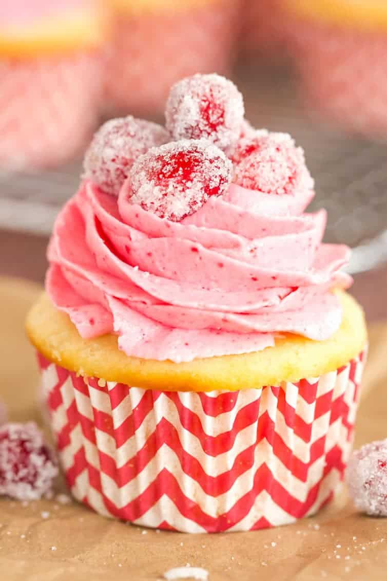 Sparkling Cranberry White Chocolate Cupcakes - Vanilla cupcakes with white chocolate ganache filling and cranberry buttercream frosting. | browneyedbaker.com