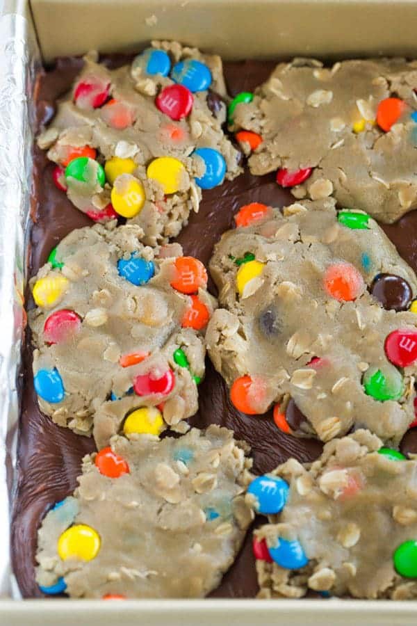 Monster cookie bars with the classic combination of peanut butter, oats, and M&Ms, plus a layer of fudge running through the center!