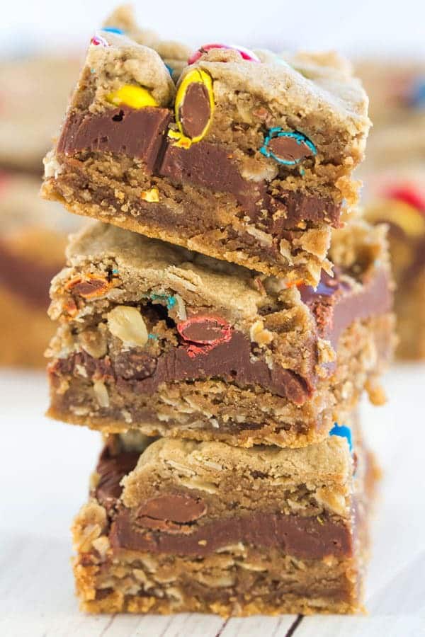Monster cookie bars with the classic combination of peanut butter, oats, and M&Ms, plus a layer of fudge running through the center!