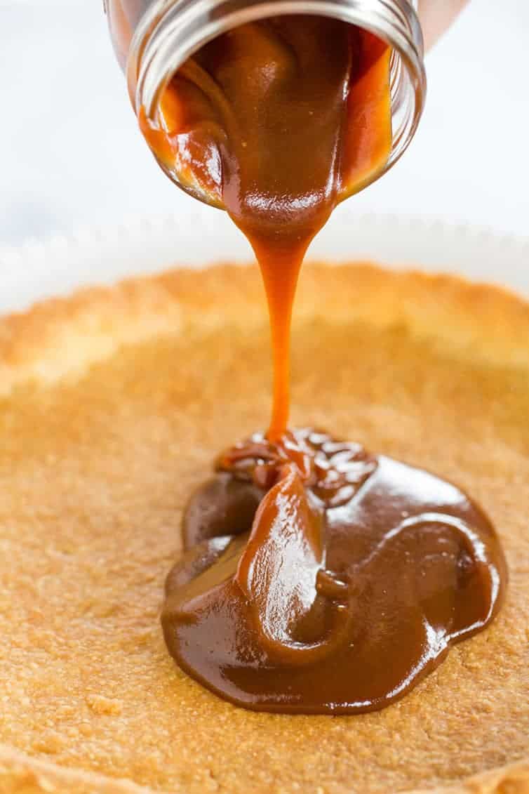 Milky Way Tart - A pate sucree crust is filled with caramel sauce and whipped milk chocolate ganache, then topped with a drizzle of caramel and chocolate curls.