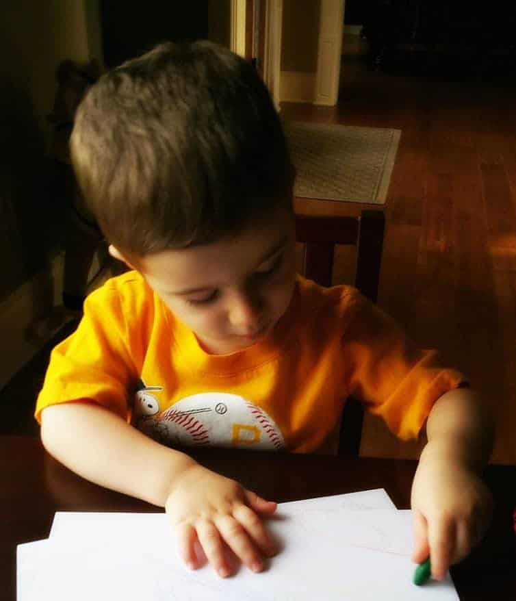 Joseph coloring at his table.
