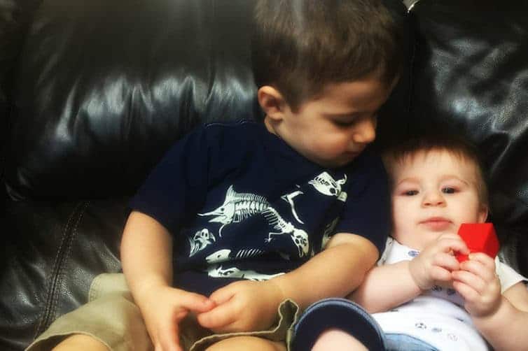 Joseph and Dominic snuggling on the couch.