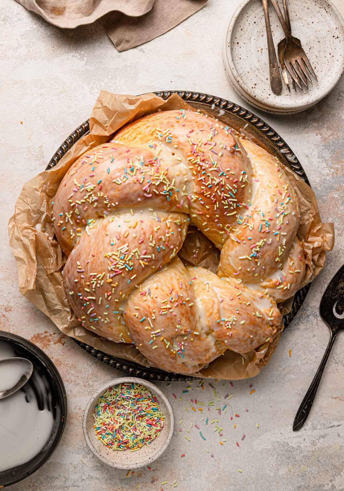 Overhead photo of Italian Easter bread with a light icing glaze and pastel sprinkles.