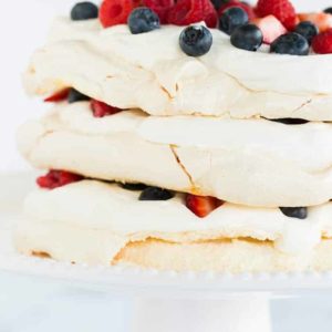 A closeup of pavlova layer cake on a cake stand.
