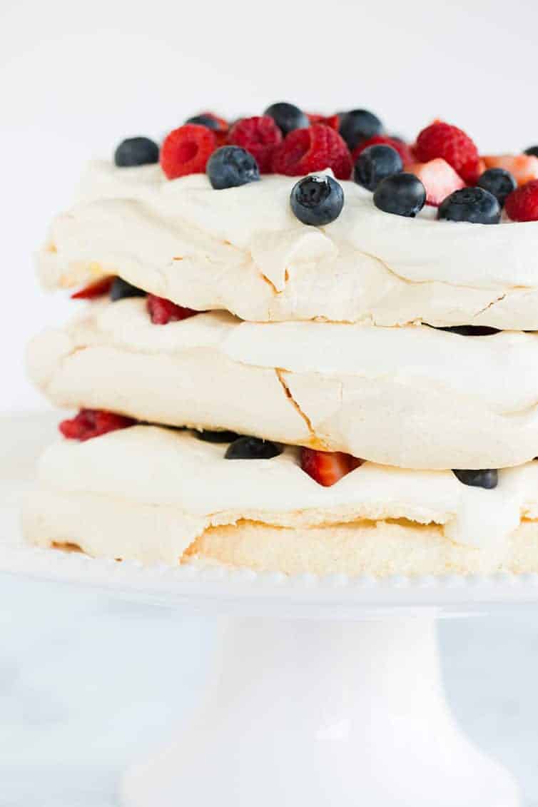 A closeup of pavlova layer cake on a cake stand.