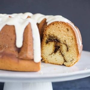 A beautiful bundt coffee cake with cinnamon swirls and cream cheese icing.