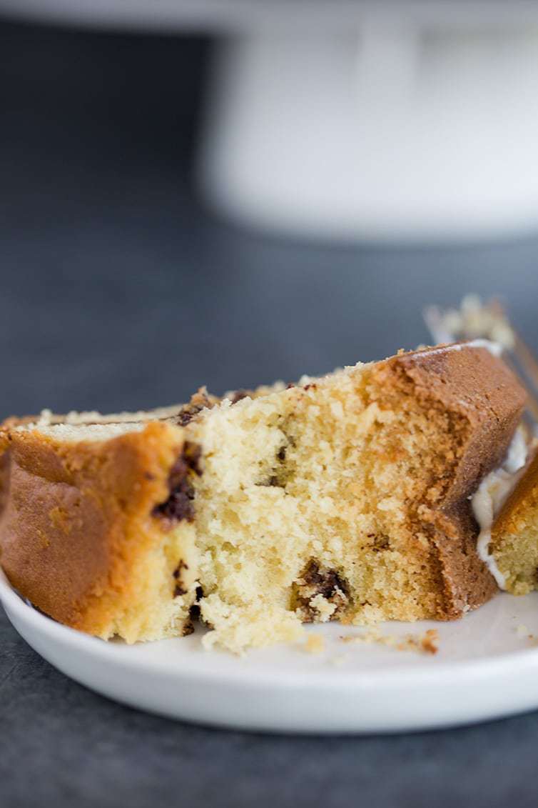 Taking a big bite out of a slice of cinnamon coffee cake.