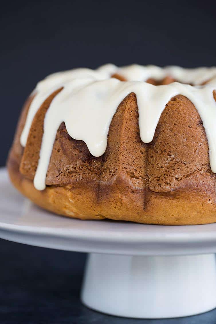 Cinnamon Coffee Cake baked in a Bundt pan, covered in cream cheese icing.