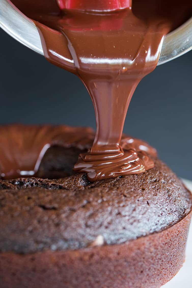 Pouring the chocolate ganache over Grammy Cake.
