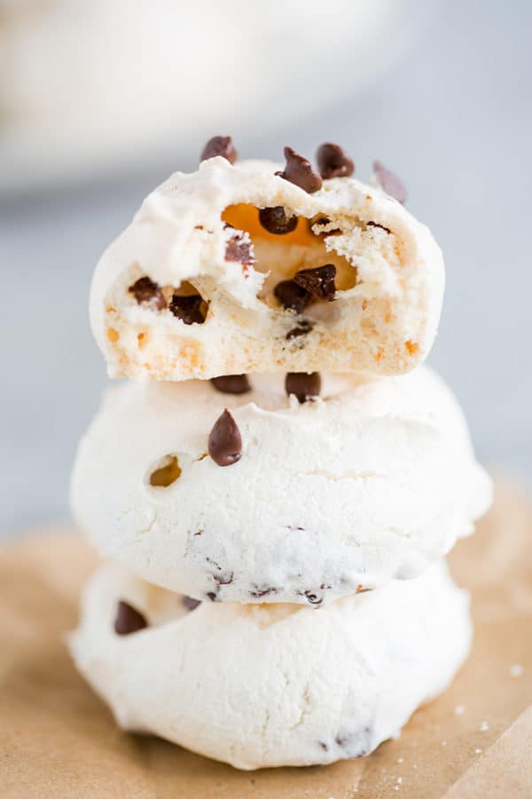 A stack of chocolate chip meringue cookies with a bite taken out!
