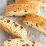 Soft biscotti sliced and laying on parchment paper.